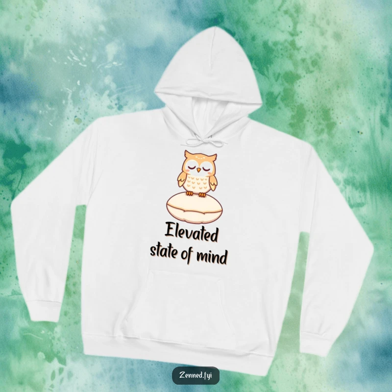 Funny owl character peacefully levitating above a cushion on a warm, magical, and humorous hoodie.