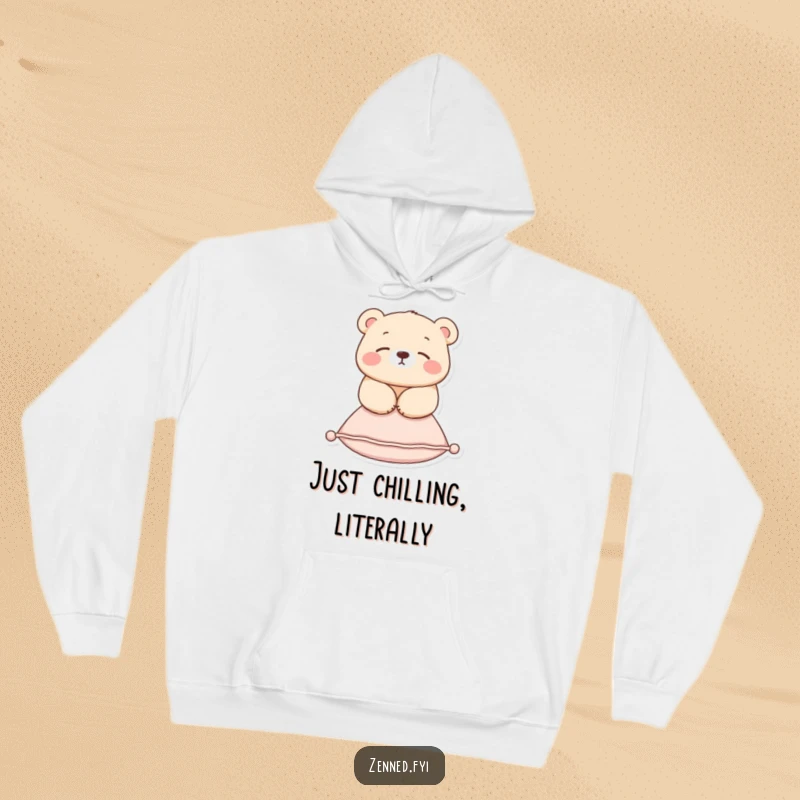 Funny hoodie displaying a tranquil bear suspended in mid-air above a small cushion, offering warmth and humor.
